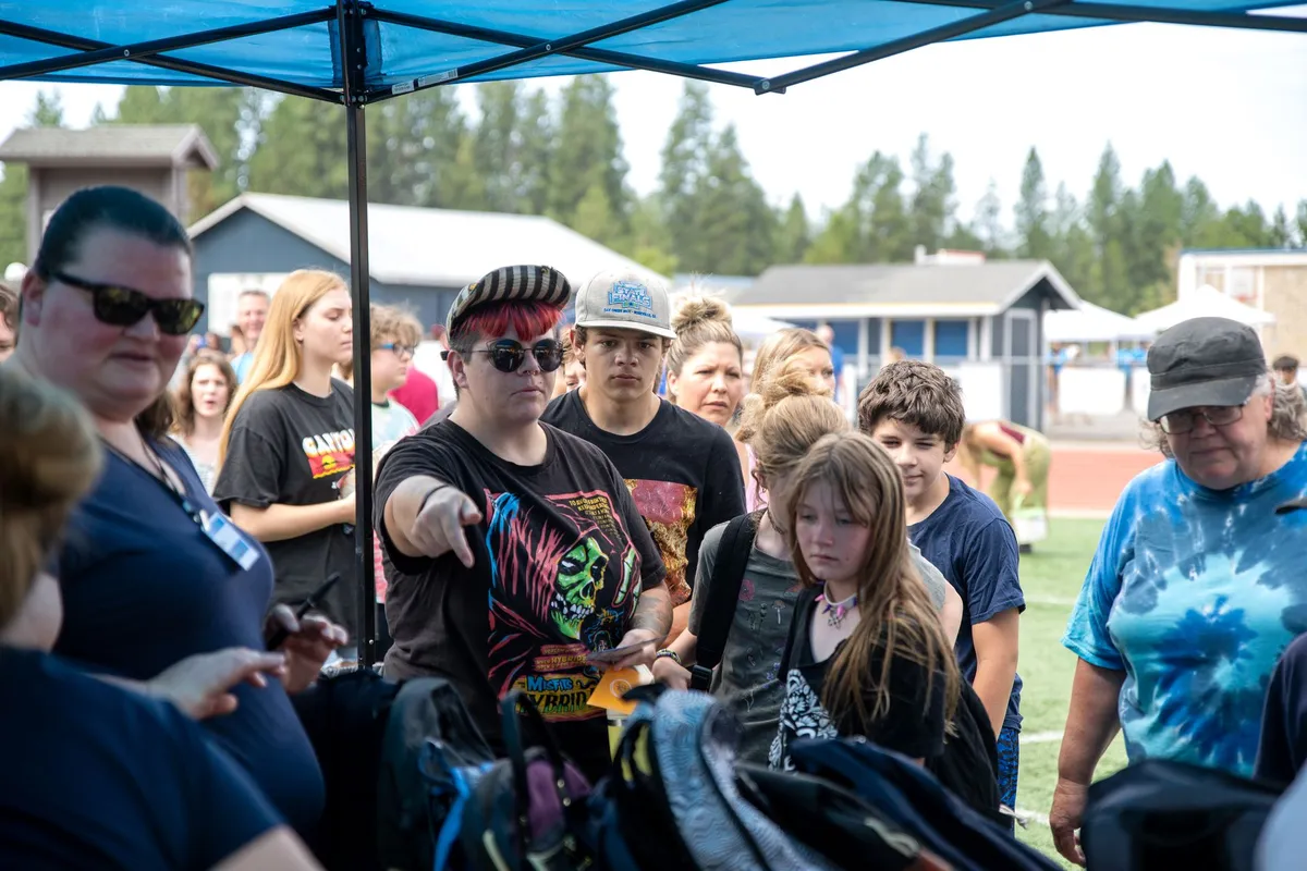 Children and adults looking through backpacks at a Hope for Nevada County event.